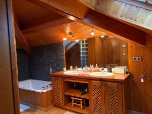 a bathroom with two sinks and a large mirror at Les Bosquitos Chalet in Ax-les-Thermes +33 photos
