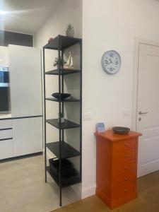 a black shelf in a kitchen next to a dresser at NONSOLOMARE wifi aria condizionata Parcheggio in Sanremo +37 photos
