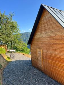 a wooden building with a small door on the side at Dreamy Garden Cabin in Gundauri