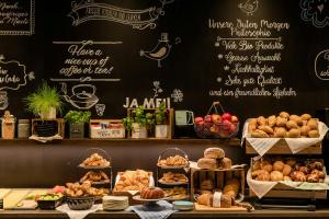 a bakery with different types of bread and pastries at Motel One München-East Side in Munich