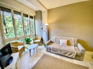 a living room with a couch and a tv at Anna Home Gallarate train station to Milan Malpensa self-check-in in Gallarate