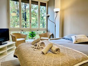 a bedroom with a bed with a stuffed animal on it at Anna Home Gallarate train station to Milan Malpensa self-check-in in Gallarate
