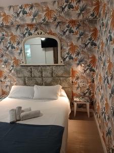 a bedroom with a bed with a mirror and a wall at Guadalupe Hostal By Torremolinos On-line in Torremolinos +132 photos