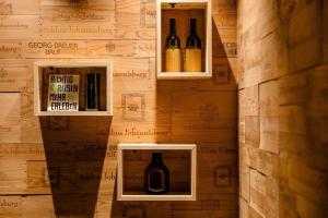 two bottles of wine in boxes on a wall at Motel One Wiesbaden in Wiesbaden +36 photos