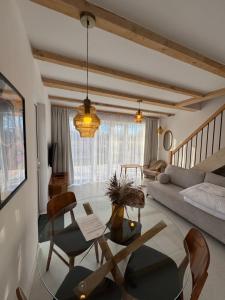 a living room with a table and a couch at Białe Tarasy in Rogowo