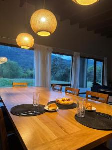 a dining room table with plates of food and glasses at Límite Sur Lodge in Trevelín