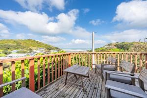 a deck with chairs and a view of the ocean at The Castle in Baylys Beach