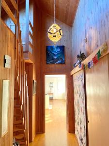 a hallway with wooden walls and a staircase in a house at Aurora beach house in Trondalen
