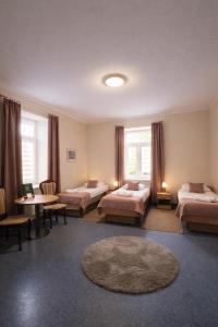 a room with two beds and a table with a rug at Zacisze Nad Nidą Resort in Pińczów +41 photos