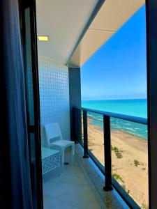a room with a balcony with a view of the beach at Refuge Beira Mar - Boa Viagem in Recife