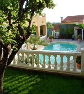 a white fence around a swimming pool in a yard at Appartement Sole e Mare in Furiani
