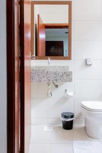 a bathroom with a sink and a toilet at Hotel Cheffer in Pôrto Ferreira +19 photos