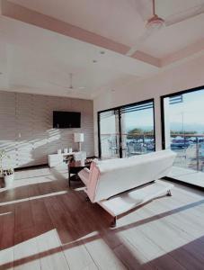 a large living room with a couch and a television at Casa Solana in Puntarenas