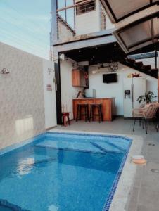 a large blue swimming pool next to a house at Casa Solana in Puntarenas