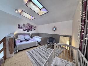 a bedroom with a bed and a chair in it at Le Céleste - Maison de vacances familiale in Châtel-Guyon