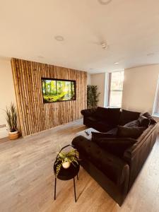 a living room with a couch and a table at Williamson Suites - Apartment 1 in Liverpool
