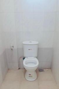 a bathroom with a white toilet in a room at Agape hostel in Bagamoyo