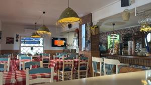 a restaurant with tables and chairs and a bar at Guadalupe Hostal By Torremolinos On-line in Torremolinos