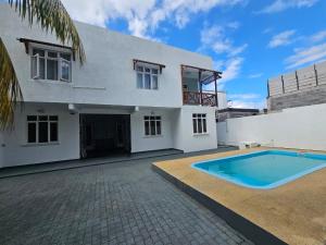 a house with a swimming pool in front of it at TecTec 2 Appartment 1 in Pereybere +12 photos