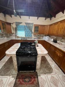 a kitchen with a stove and a counter top at Peaceful Private Home With Exclusive Swimming Pool in Montego Bay