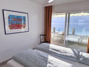 a bedroom with a bed and a view of the ocean at Residenza Acapulco I by Fewotessin in Moscia