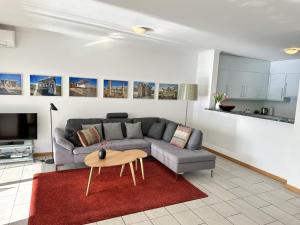 a living room with a couch and a table at Residenza Acapulco II by Fewotessin in Moscia