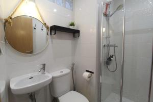 a bathroom with a toilet and a sink and a shower at Townhouse with Rooftop Terrace in Olhão in Olhão