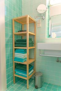 a bathroom with a rack of towels and a sink at Tomas's apartment in Ljubljana