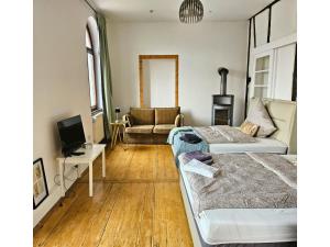 a living room with two beds and a couch at Apartment für Monteure oder Reisende in Bad Camberg
