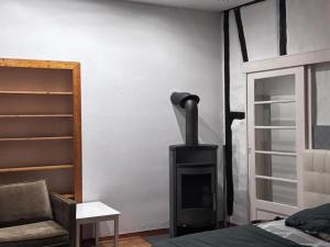 a fireplace in a bedroom with a bed and a chair at Apartment für Monteure oder Reisende in Bad Camberg