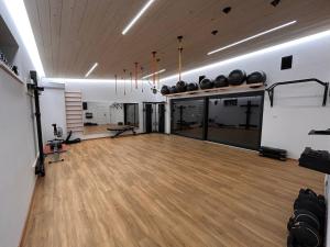 a large room with a gym with a wooden floor at FamilyFitHouse in Bystrzyca