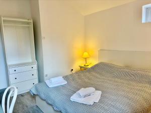 a bedroom with a bed with two towels on it at Apartments Mare in Mlini