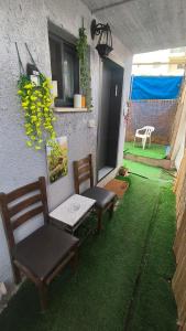 a patio with two chairs and a table and a window at נופש חלומי בכנרת in Tiberias