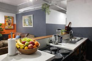 a bowl of fruit on a counter in a kitchen at Warm & Luxury Stay at Maboneng with Kingbed HugeTV WiFi in Johannesburg +42 photos