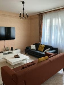 a living room with a couch and a table at Agréable maison in Pons