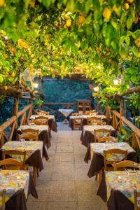 a row of tables in a restaurant with trees at Agriturismo da Regina in Tramonti