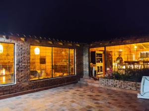 a store front with illuminated windows at night at La Toscana, Chalet Campestre in Guasca