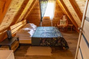 a bedroom with a bed in a wooden cabin at Słoneczna Przystań in Sasino