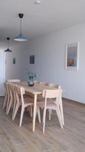 a dining room table and chairs with a vase on it at Peprina Apt 2 in Central Rabat in Rabat