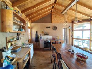 a kitchen with a large wooden table in a room at Casa La Virgen in Burro Muerto