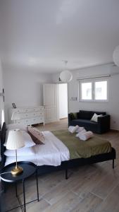 a bedroom with a large bed and a couch at Peprina Apt 2 in Central Rabat in Rabat