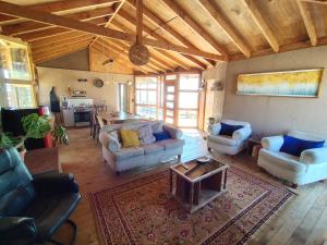 a large living room with couches and a table at Casa La Virgen in Burro Muerto