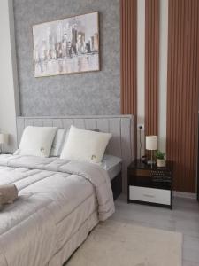 a bedroom with a bed and a table with a night stand at Bella Apartment in Ruse