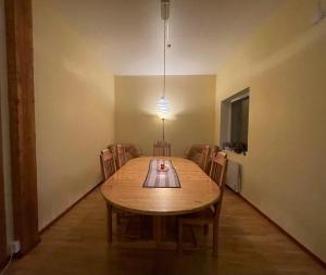 a dining room table with chairs and a light fixture at Laplanders room 4 in Kiruna +5 photos