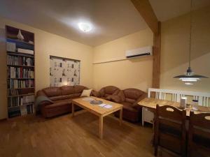 a living room with a couch and a table at Laplanders room 4 in Kiruna
