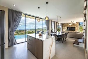 a kitchen and dining room with a view of a living room at Villa 360 in Calaca
