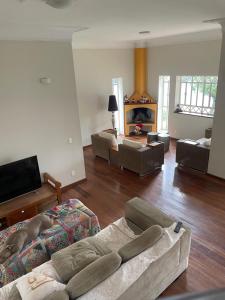 a living room with a couch and a fireplace at Casa para alugar 3 suítes e um Quarto in Campinas