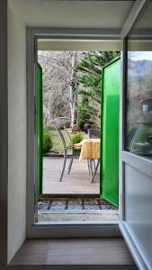 an open door to a patio with a table at Mon Refuge B&B in Jougne