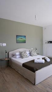 a large bed in a white room with at Peprina Penthouse in Central Rabat in Rabat