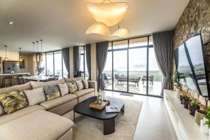 a living room with a couch and a table at Villa 360 in Calaca